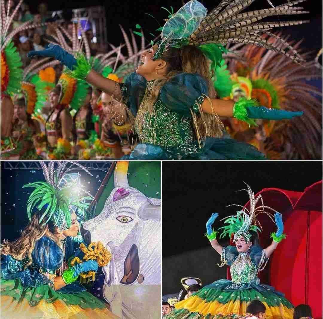 DanÃ§arina em destaque com traje verde e azul rodopiando
